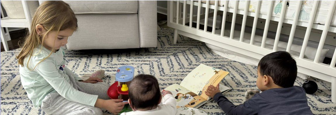 Children reading and playing together at home